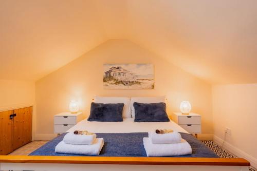 a bedroom with a large bed with two pillows at Sleeps 6 off street parking close to city in Chester