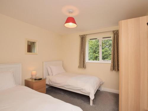 a bedroom with two beds and a window at 3 Bed in Rowlands Gill oc-cn209 in Rowlands Gill