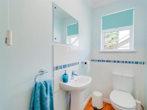 a white bathroom with a sink and a toilet at 2 Bed in Brighstone oc-ic132 in Brighstone