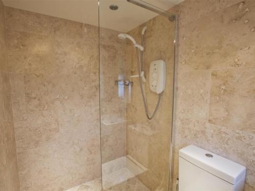 a shower stall in a bathroom with a toilet at 4 Bed in Kettlewell oc-g0041 in Starbotton