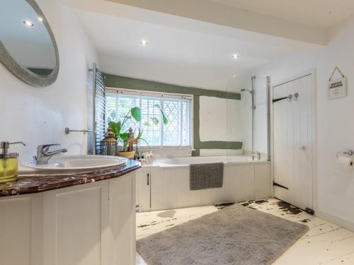 a bathroom with a sink and a mirror at 6 Bed in Lymington oc-56765 in Boldre