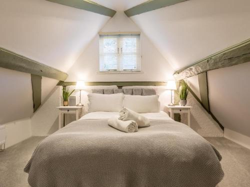 a bedroom with a large bed in a attic at 6 Bed in Lymington oc-56765 in Boldre