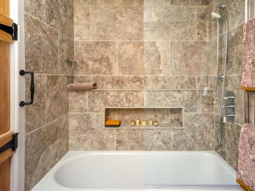 a bathroom with a tub and a shower at 1 Bed in Sherborne oc-87292 in Lillington