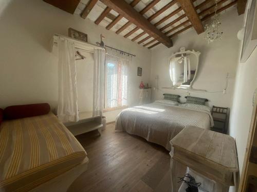 a bedroom with two beds and a table and a mirror at Ca' Barbona in Lido di Classe