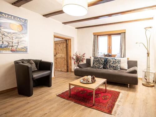 a living room with two couches and a coffee table at Apartment Chesa Treig by Interhome in Samedan