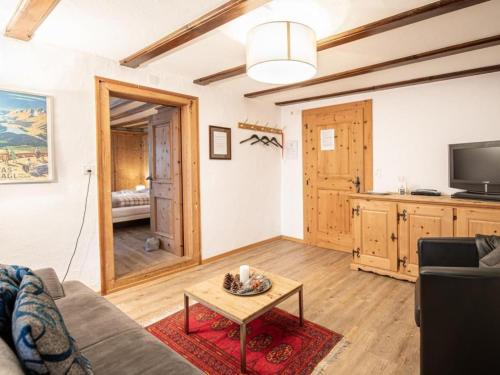 a living room with a couch and a table at Apartment Chesa Treig by Interhome in Samedan
