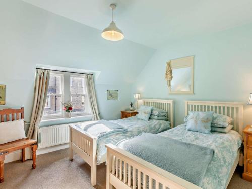 a bedroom with two beds and a window at 3 Bed in Backworth oc-cn013 in Backworth