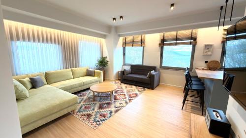 a living room with a couch and a chair at Kyveli Lake Suite in Kastoria