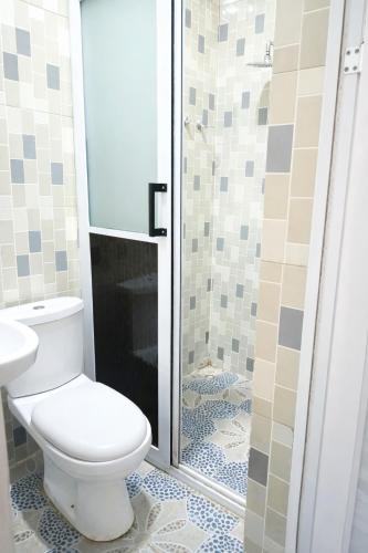 a bathroom with a toilet and a shower at CJ apartment kasoa in Kasoa