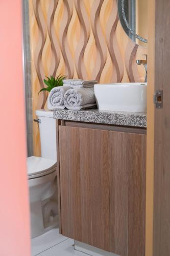 a bathroom with a sink and a toilet at Rosarito Papas & ocean view Condo in Rosarito