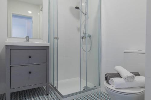 a bathroom with a shower and a toilet and a sink at Carcavelos Village I by Staycalm in Carcavelos