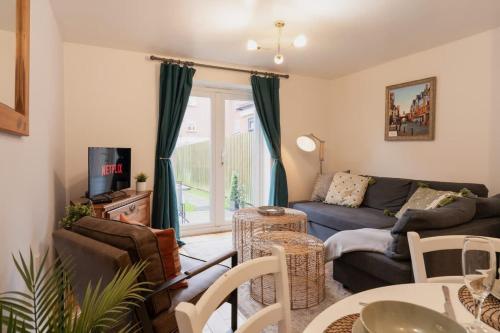 a living room with a couch and a tv at Stylish Chester Stay Free Parking Private Garden in Chester
