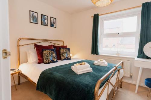 a bedroom with a bed with towels on it at Stylish Chester Stay Free Parking Private Garden in Chester