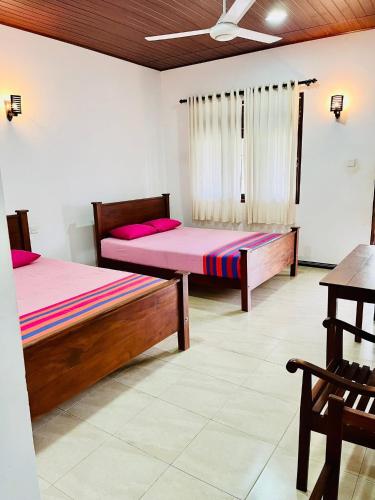 a bedroom with two beds in a room at Flourish holiday resort in Kataragama