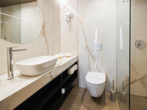 a bathroom with a sink and a toilet at Wine Paradise - Glamping resort in Marezige