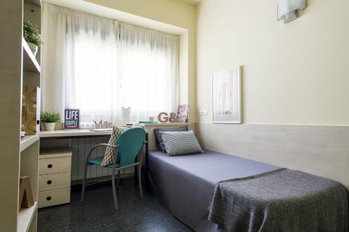 a bedroom with a bed and a desk and a window at Residencia Universitaria Resa Erasmo in Madrid