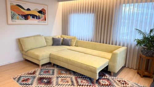 a living room with a couch and a rug at Kyveli Lake Suite in Kastoria
