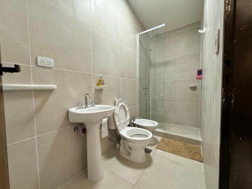 a bathroom with a toilet and a sink and a shower at Complejo La Mística in Copacabana