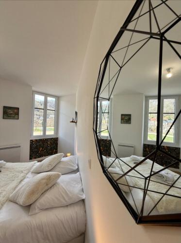 a bedroom with two beds and a mirror on the wall at Parenthèse en Savoie in Albertville