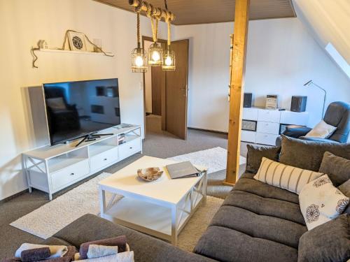 a living room with a couch and a tv at Apartment Graugans by Interhome in Freiburg - Elbe