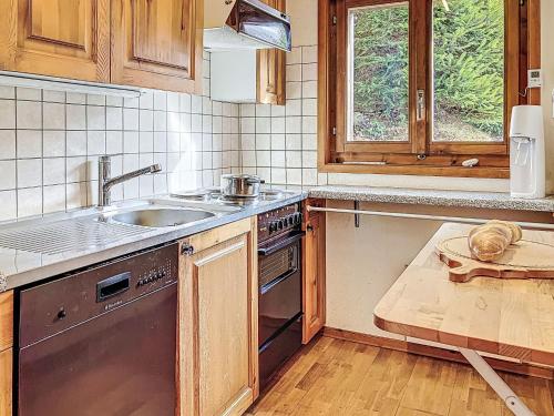 a kitchen with a sink and a stove at Chalet Chalet chemin du four by Interhome in Morgins