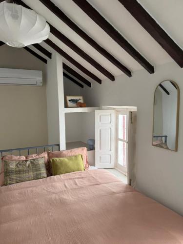 a bedroom with a large bed and a mirror at Casa Cookie in Ojén
