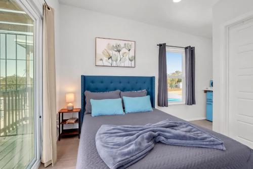 a bedroom with a bed with a blue headboard at The Container Retreat - 2B in Canyon Lake