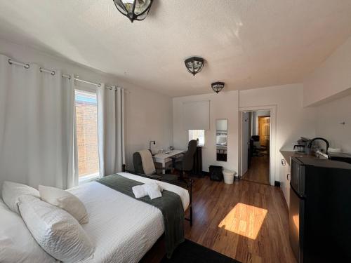 a bedroom with a bed and a desk in it at Stone House Kenora in Kenora