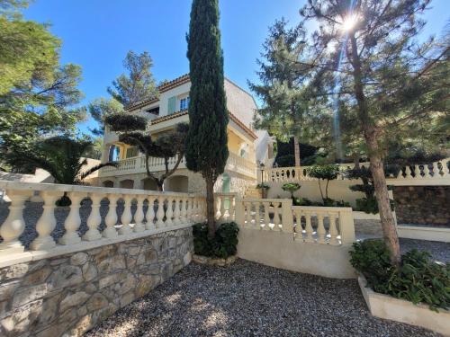 a white fence in front of a house at Villa Palama in Marseille