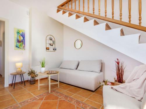 a living room with a white couch and stairs at Villa Can Gordei by Interhome in Albinyana