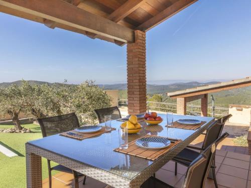 a blue table with chairs on a patio with a view at Villa Can Gordei by Interhome in Albinyana