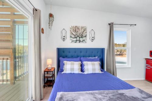 a bedroom with a blue bed with a blue headboard at The Container Retreat - 3B in Canyon Lake