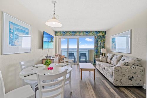 a living room with a table and a couch at Oceanfront Bay Watch 1BR with Resort Amenities 1707 in Myrtle Beach