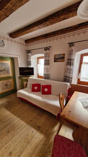 a bedroom with a bed with red pillows on it at Casa di Chiara in Padola