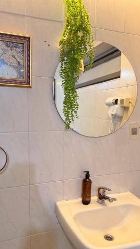 a bathroom with a sink and a mirror at Hotel Hassler in Asunción