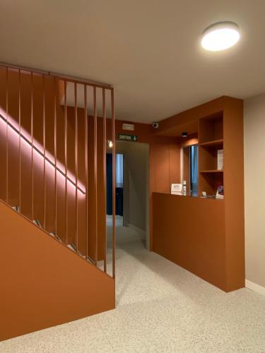 an office lobby with a staircase and a desk at Pensión Coral in Barcelona