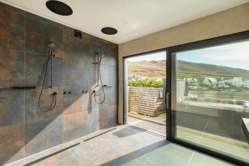 a bathroom with two showers and a large window at 5 Bed in Mortehoe oc-c30855 in Mortehoe