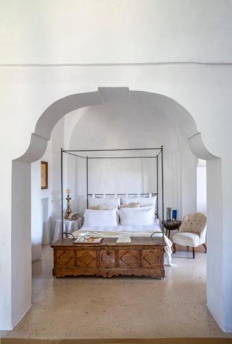 a bedroom with a large bed in an arch way at Masseria Buganvillea in Fasano
