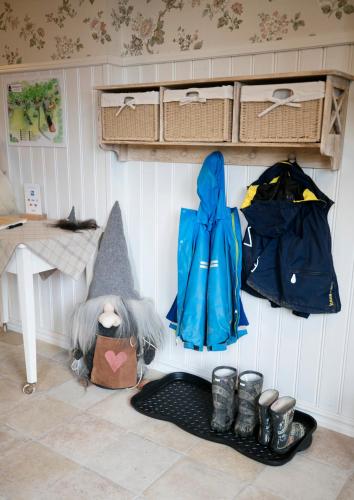 a corner of a room with clothes and shoes at Mellangården in Västerbykil
