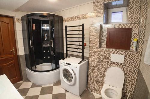 a bathroom with a washing machine and a toilet at Apartmán Eskadra 1 in Horní Malá Úpa