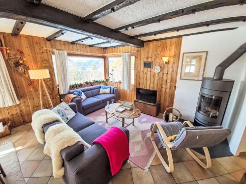 a living room with a couch and a fireplace at Chalet Chalet Le Rhônasson by Interhome in Vercorin