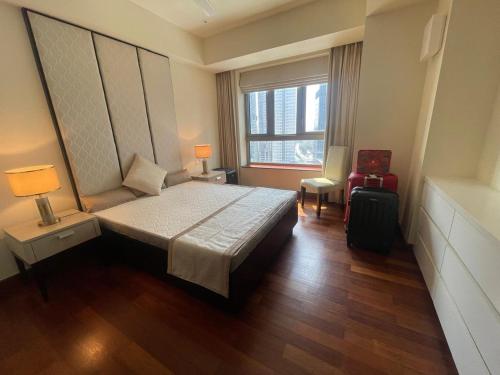a bedroom with a large bed and a window at Cinnomon Life Residence Tower 20 3 in Colombo