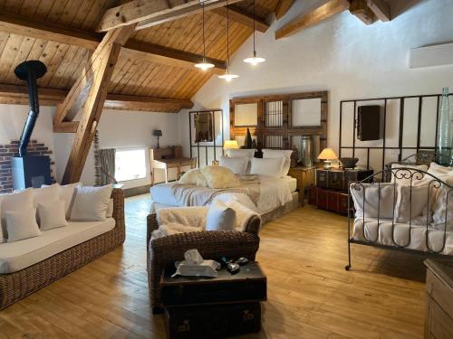 a large room with a bed and a couch at Le Moulin de Visargent in Sens sur Seille