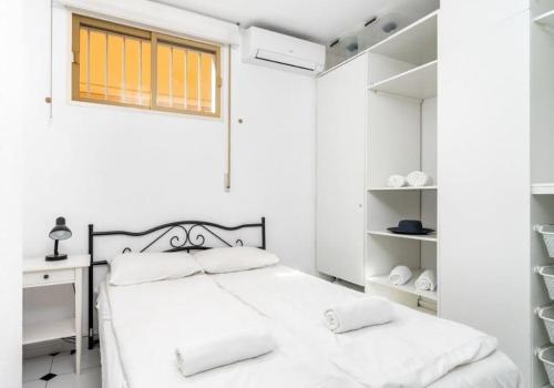 a white bedroom with a bed and a desk at Beachfront in Benalmadena by Costarentals - Ref 70 in Benalmádena