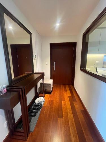a room with a mirror and a wooden floor at Cinnomon Life Residence Tower 20 3 in Colombo