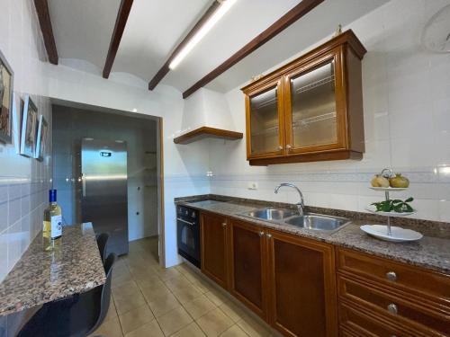 a kitchen with a sink and a counter top at Villa con piscina y barbacoa en Calpe in Calpe