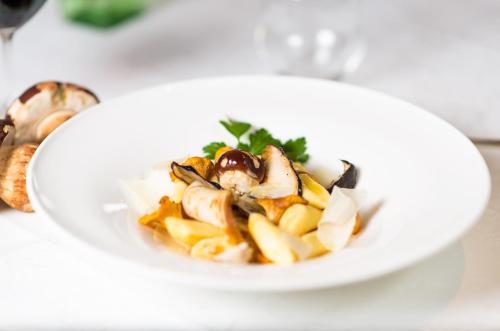a white plate of food on a table at Hotel Regina in Soprabolzano