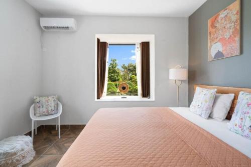 a bedroom with a large bed and a window at Balaclava Star Villa in Balaclava