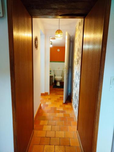 a hallway leading to a bathroom with a toilet at Petite parenthèse au gîte Layon in Les Garennes sur Loire