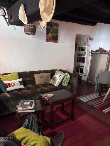 a living room with a couch and a table at Maison de village in Ortiporio